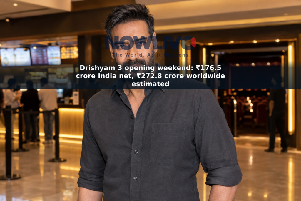 Staged editorial-style portrait of Ajay Devgn in a softly lit cinema foyer.