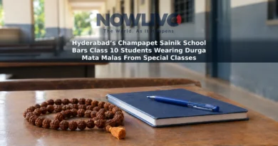 A devotional mala beside a notebook on a school desk, with a corridor blurred in the background