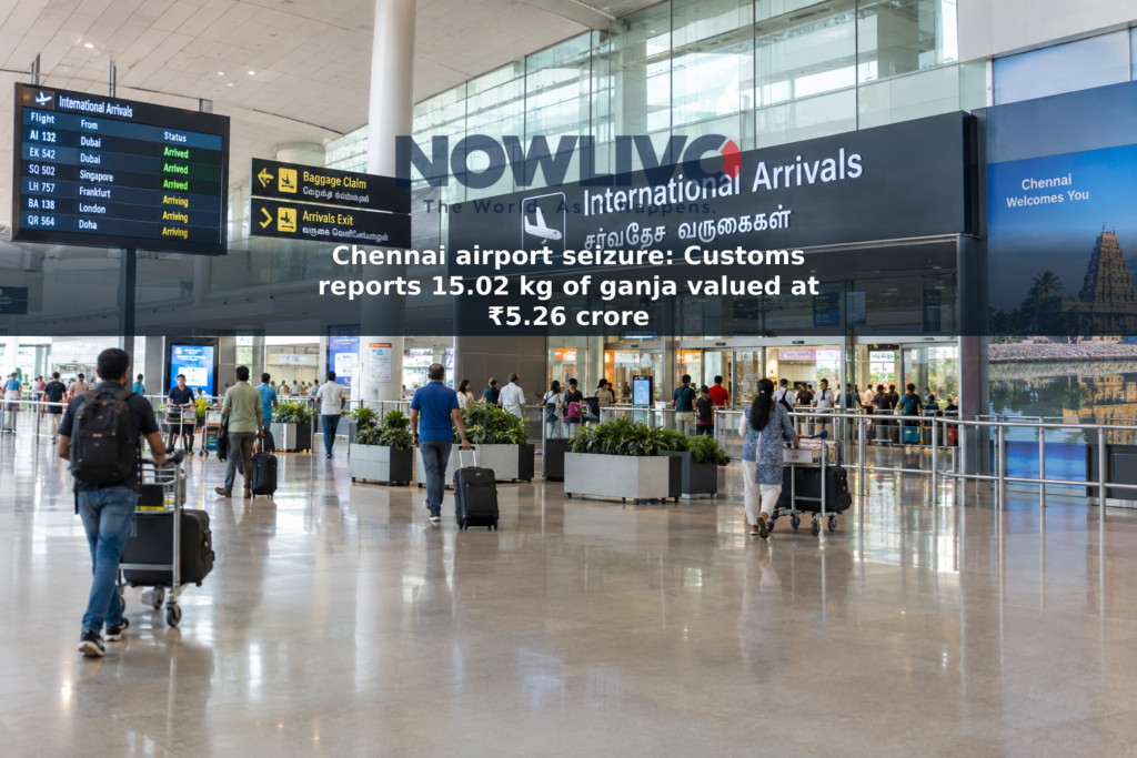 Travelers and baggage trolleys in an airport arrivals area in Chennai.