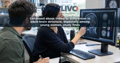 Adult researchers review an illustrative brain MRI image on a computer in a neuroscience workspace.