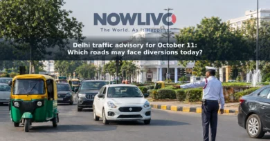 Traffic moving through a central New Delhi junction as a traffic officer directs vehicles.