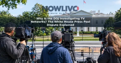 Television news cameras in a press area with the White House visible in the background.