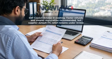An accountant reviews GST paperwork and a refund form at an office desk.