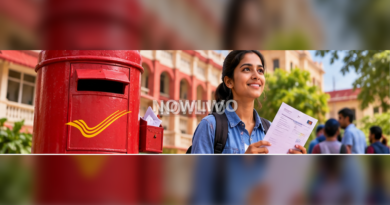 Young Indian applicant checking a phone outside a post office with documents in hand