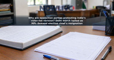 Blank voter-registration forms and an electoral-roll register on an office desk.