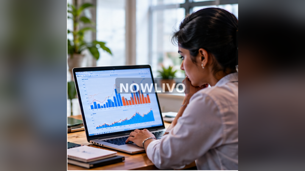 Analyst comparing India and US charts on laptop; generated editorial illustration, centered NOWLIVO watermark.