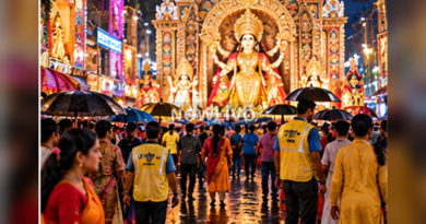 Kolkata Durga Puja pandal illuminated in rain with orderly pedestrian queues and umbrellas