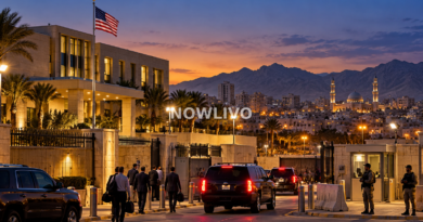 Editorial illustration of a secured US embassy compound in a Middle Eastern city at dusk, with vehicles, security staff and a distant skyline.