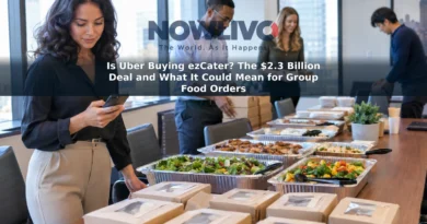 An office lunch organizer checks a phone beside trays and boxed meals set out on a conference table.