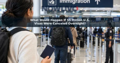 Adult traveler holding a passport in an airport arrivals hall, with an immigration checkpoint in the distance.