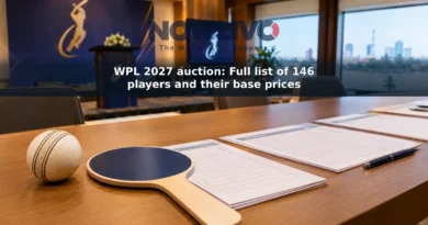 Cricket ball, auction paddle and roster sheets arranged on a table ahead of a women's cricket player auction